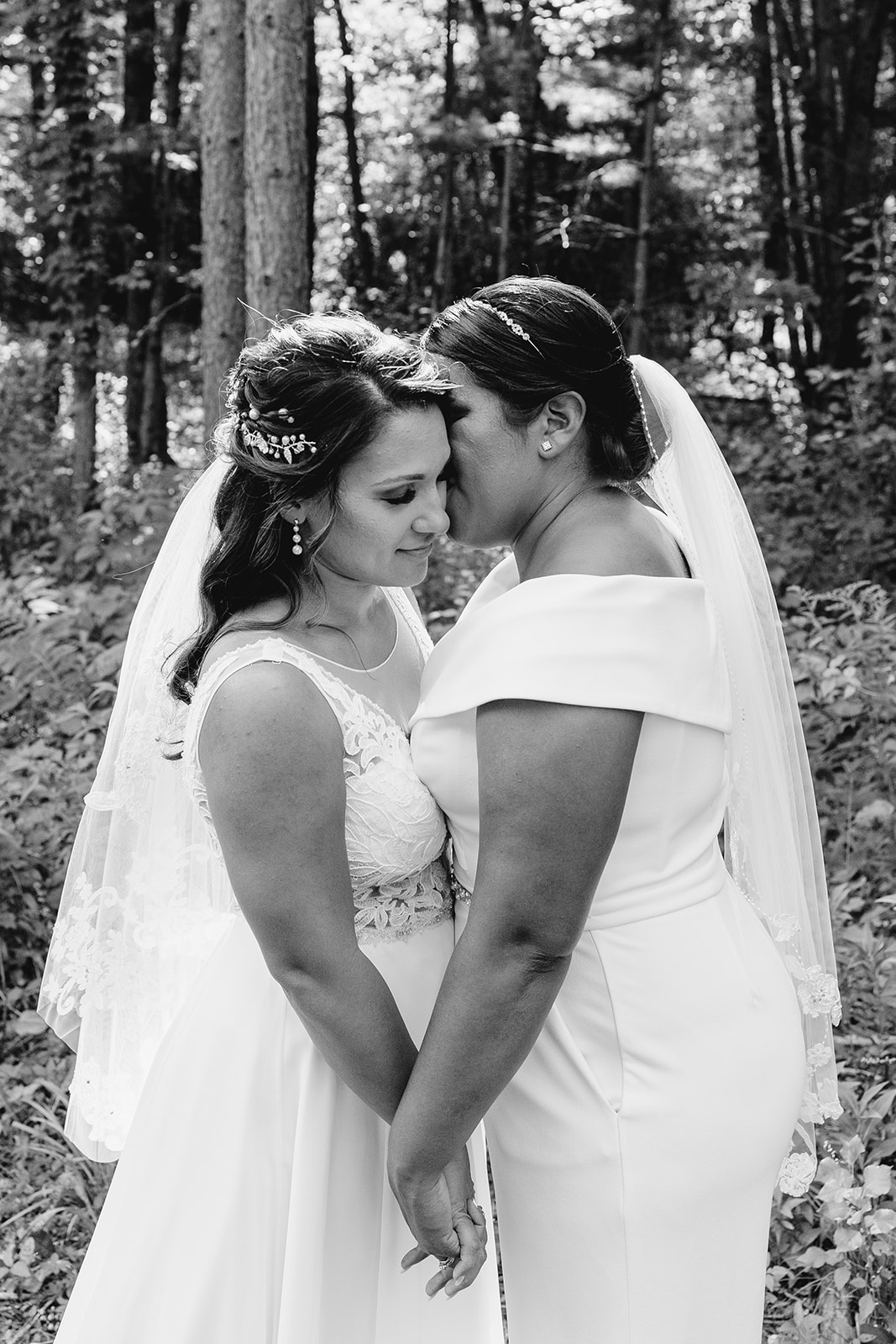 couple embraces in the woods on their wedding day in central wisconsin