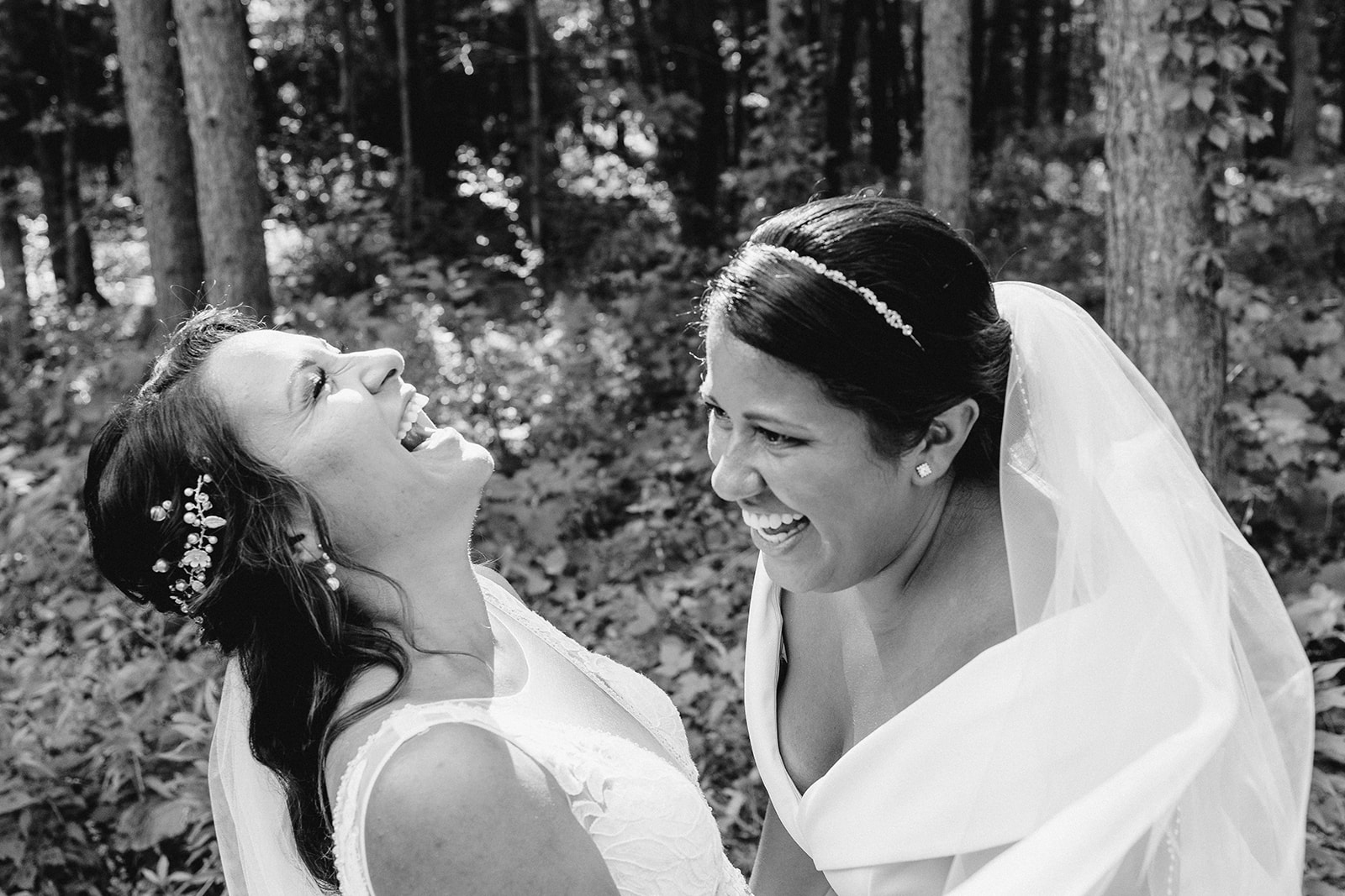 couple laughs in the woods on their wedding day in central wisconsin