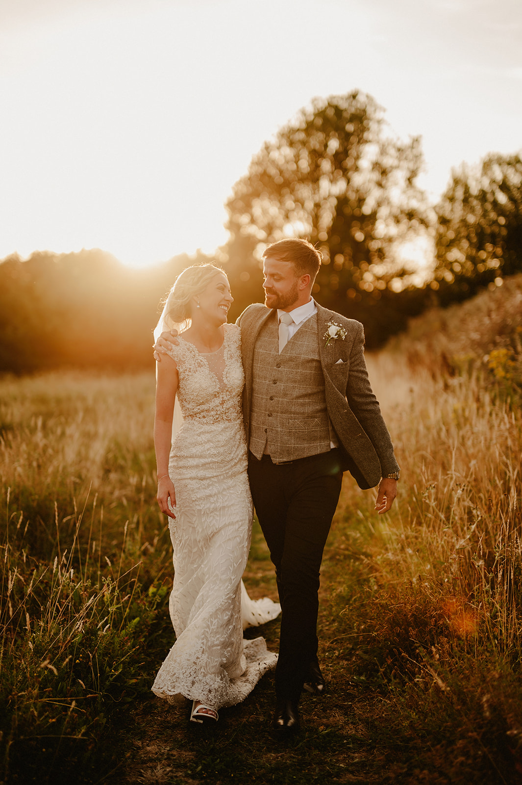 a golden hour wedding photography portrait of a bride and groom smiling at villiers barn