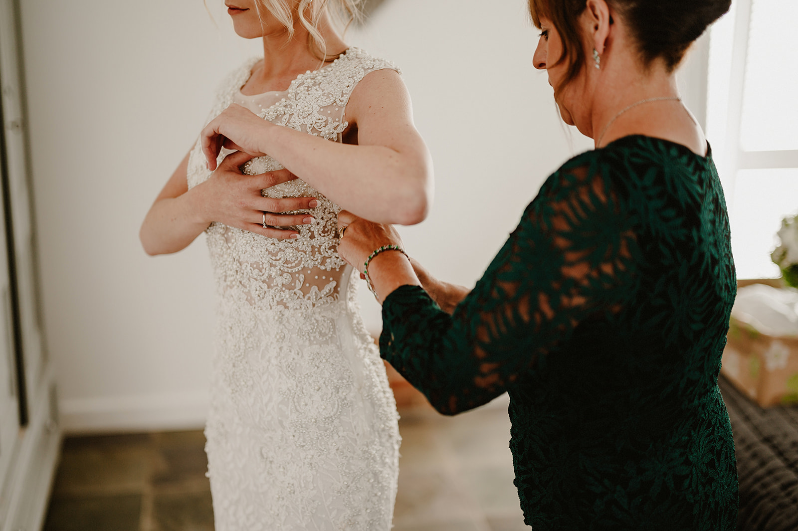 a mother of the bride adjusting a wedding dress at villiers barn