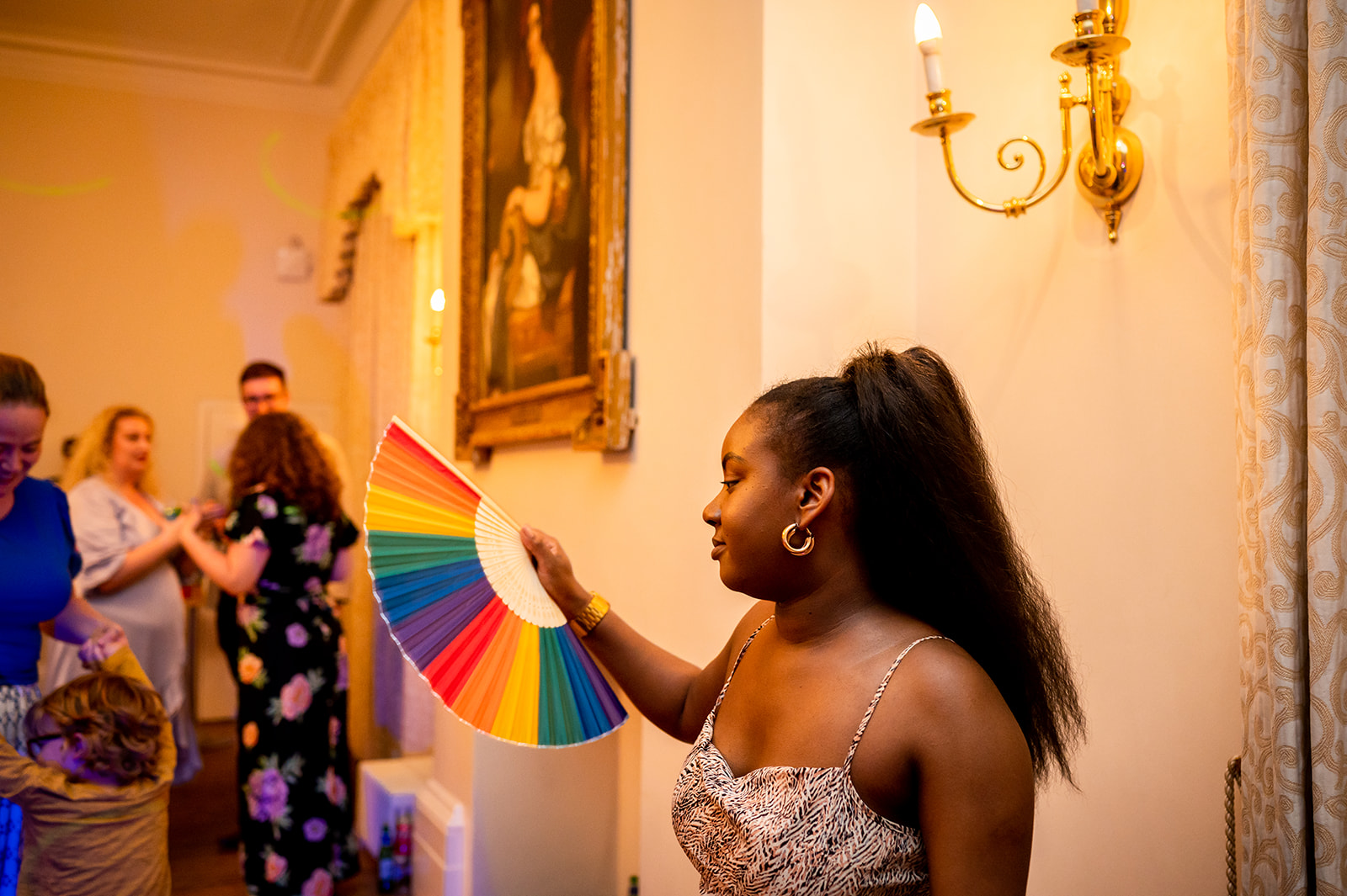 guest with LGBTQ + flag at wedding at Kew Gardens Cambridge Cottage