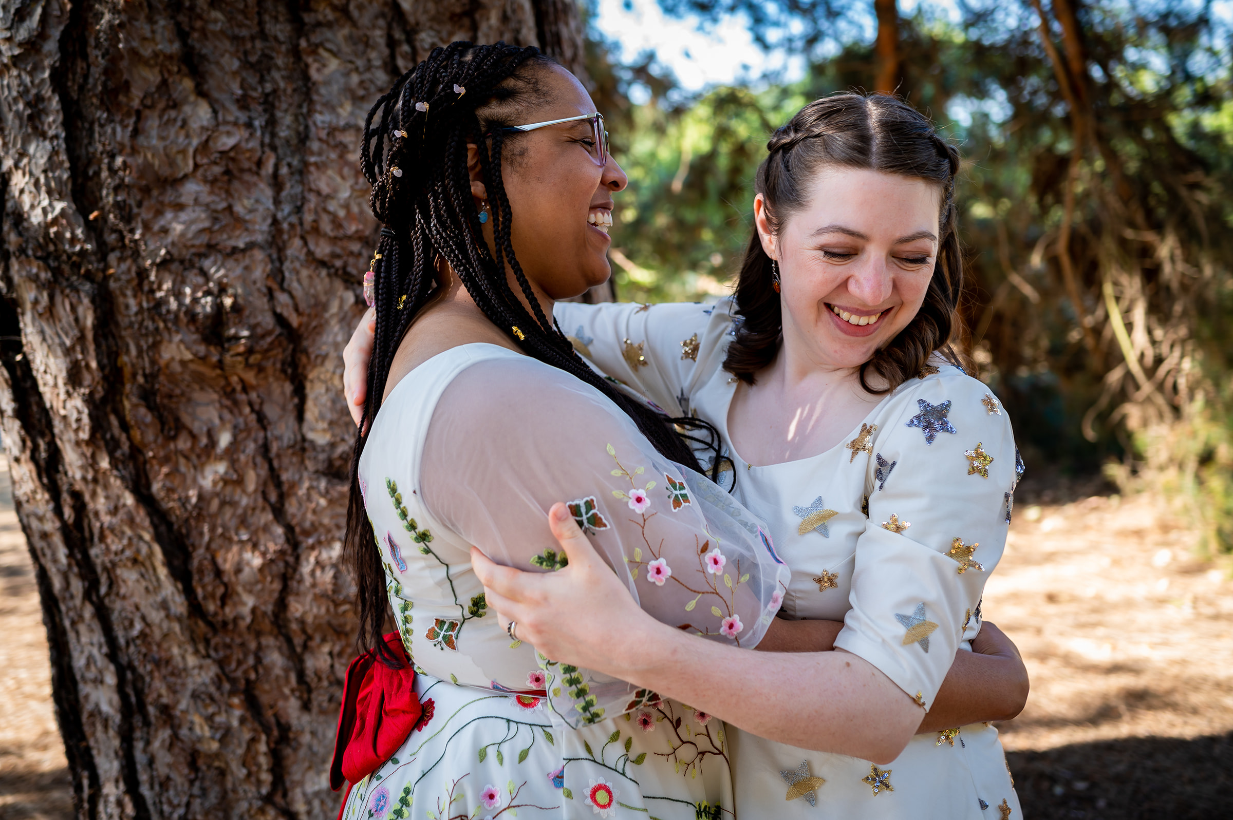 LGBTQ+ brides in front of tree at Kew Gardens