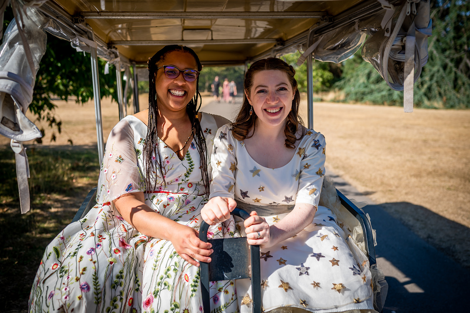 two brides seated in their buggy at kew gardens LGBTQ + wedding