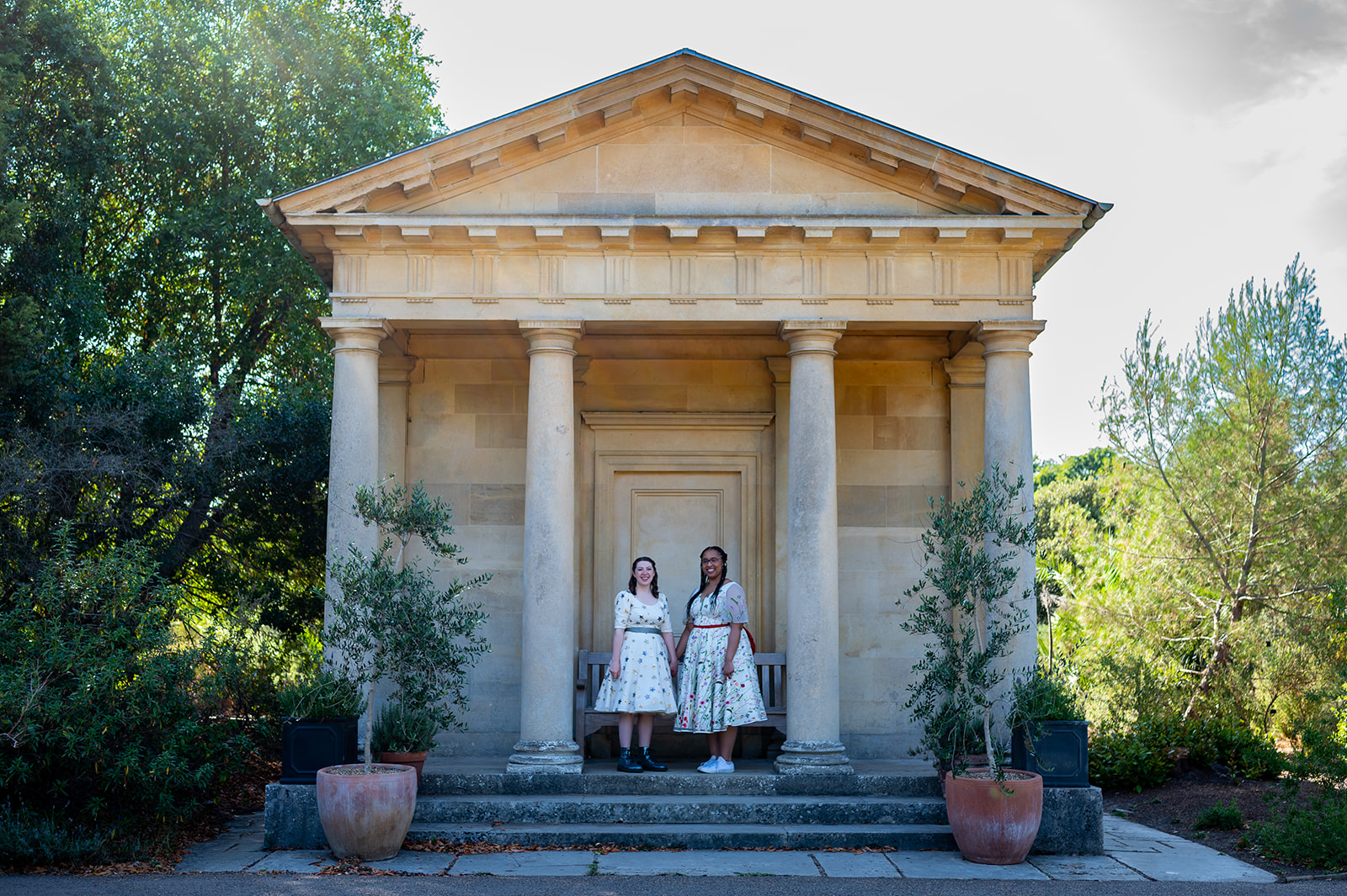 two brides standing in front of building at kew gardens LGBTQ + wedding