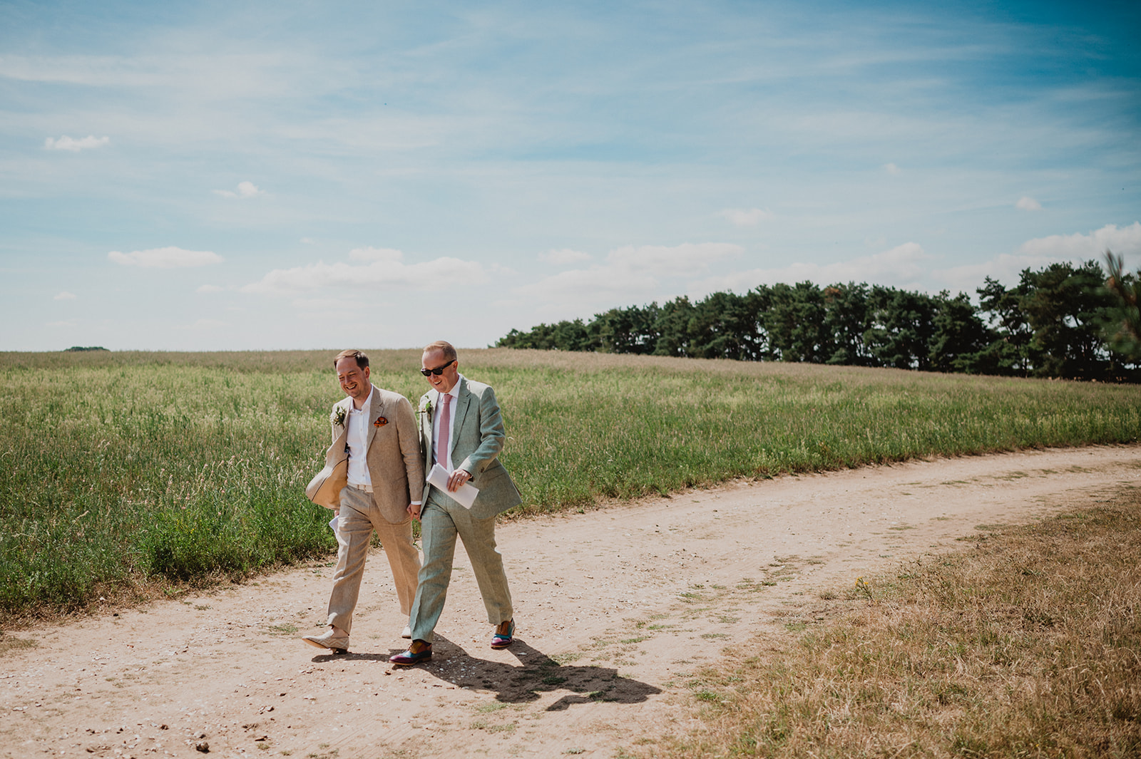 A same sex male couple take a stroll in the Norfolk countryside