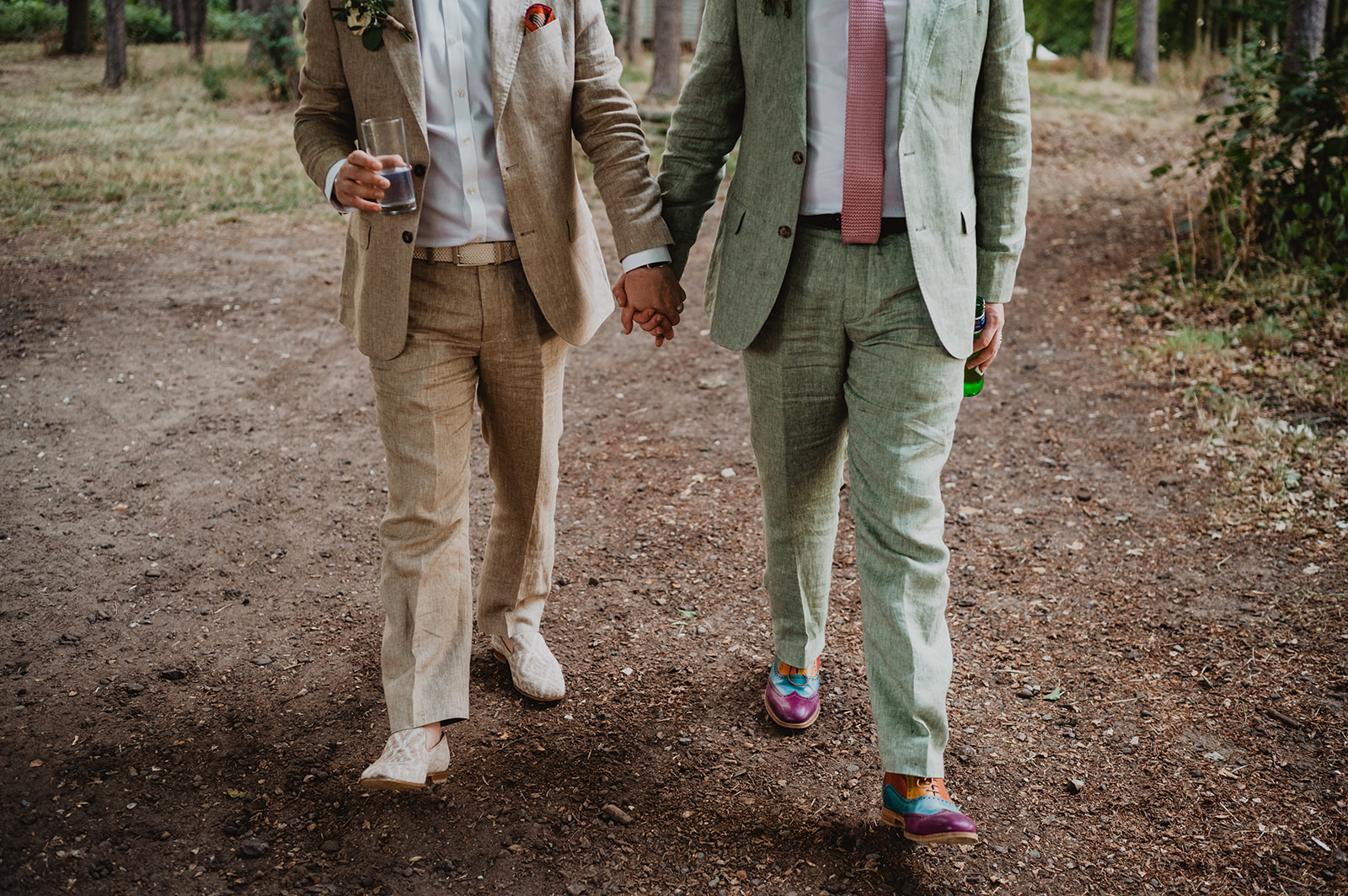 A same sex male couple hold hands and go for a walk at Happy Valley Norfolk