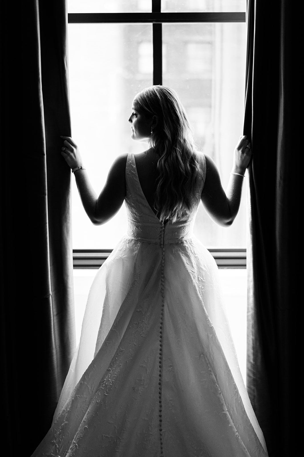 Blackstone Chicago Wedding Photography- bride by a window with curtains epic black and white photo