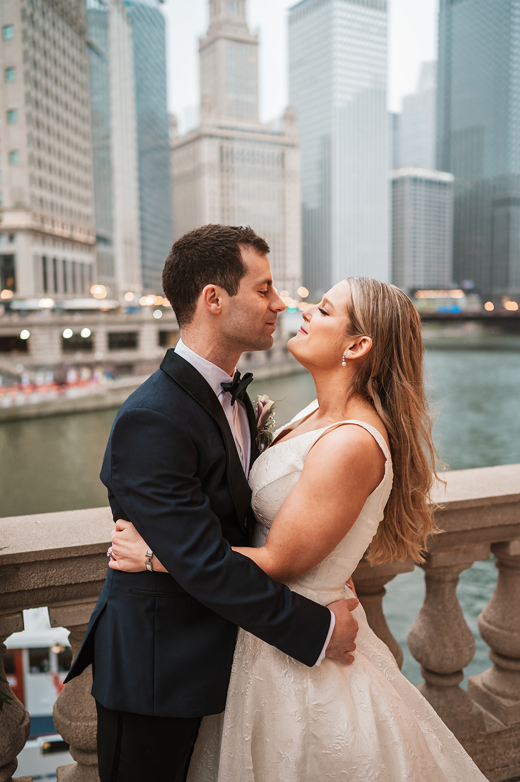 Bride and groom at the end of the winter on riverwalk by the Wrigley building chicago