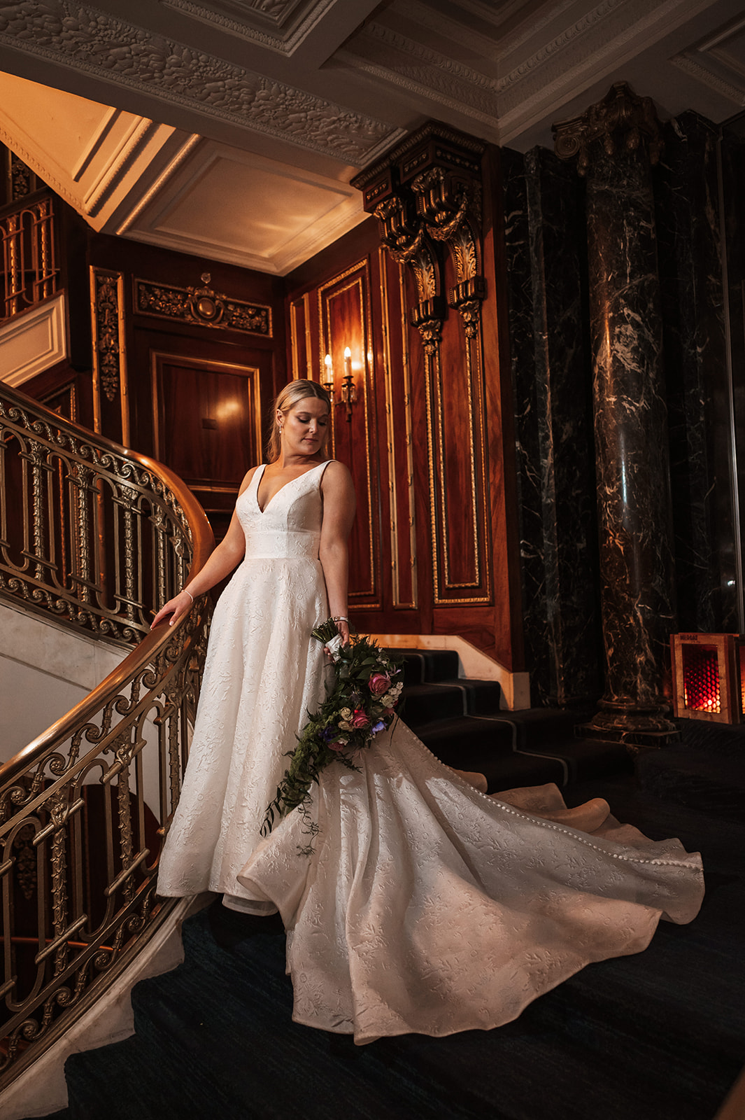 Bride and groom at the staircase of The Blackstone hotel in chicago