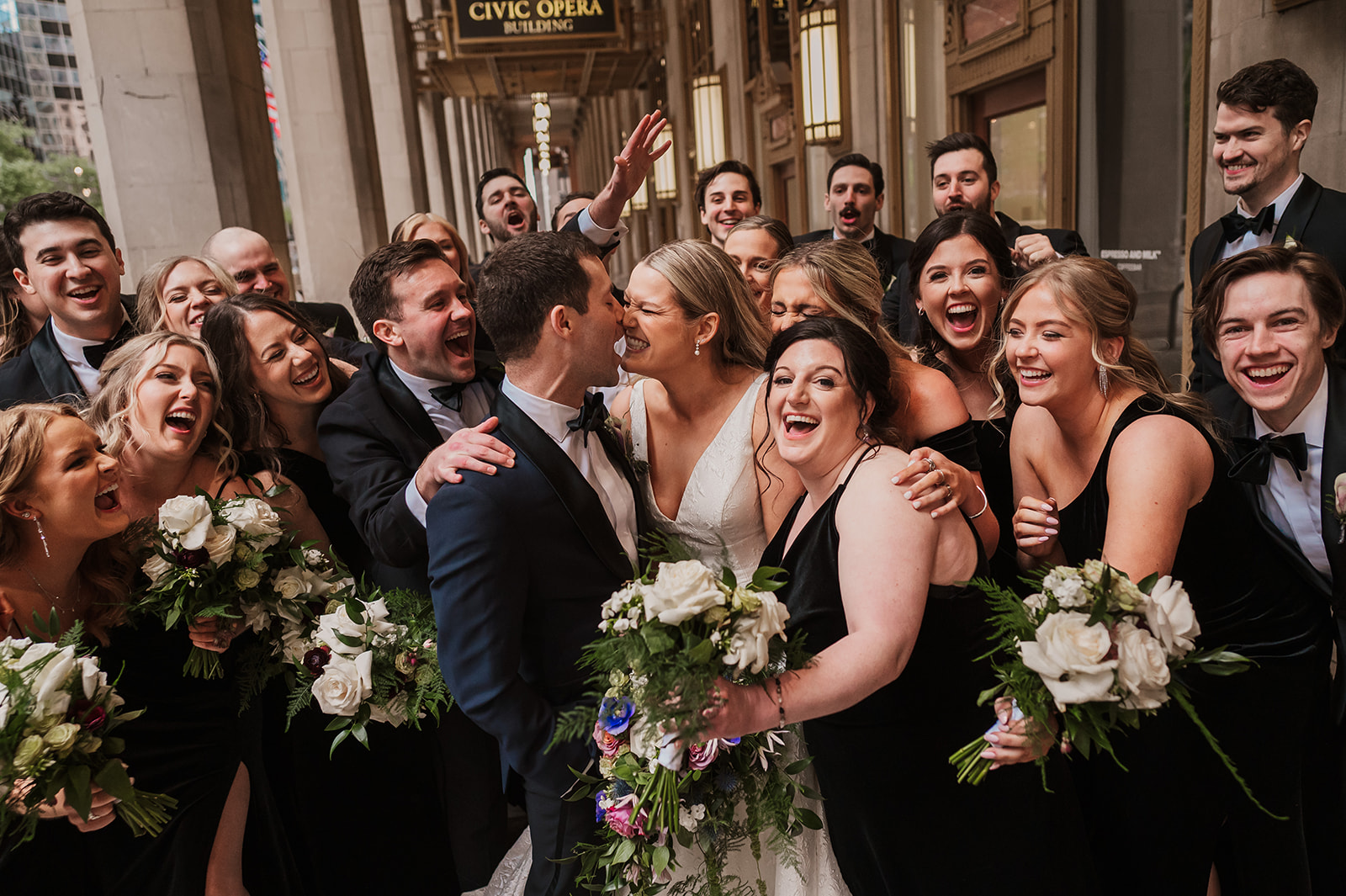 crazy wedding party photos at the Lyric Opera Chicago. black dresses and black suits