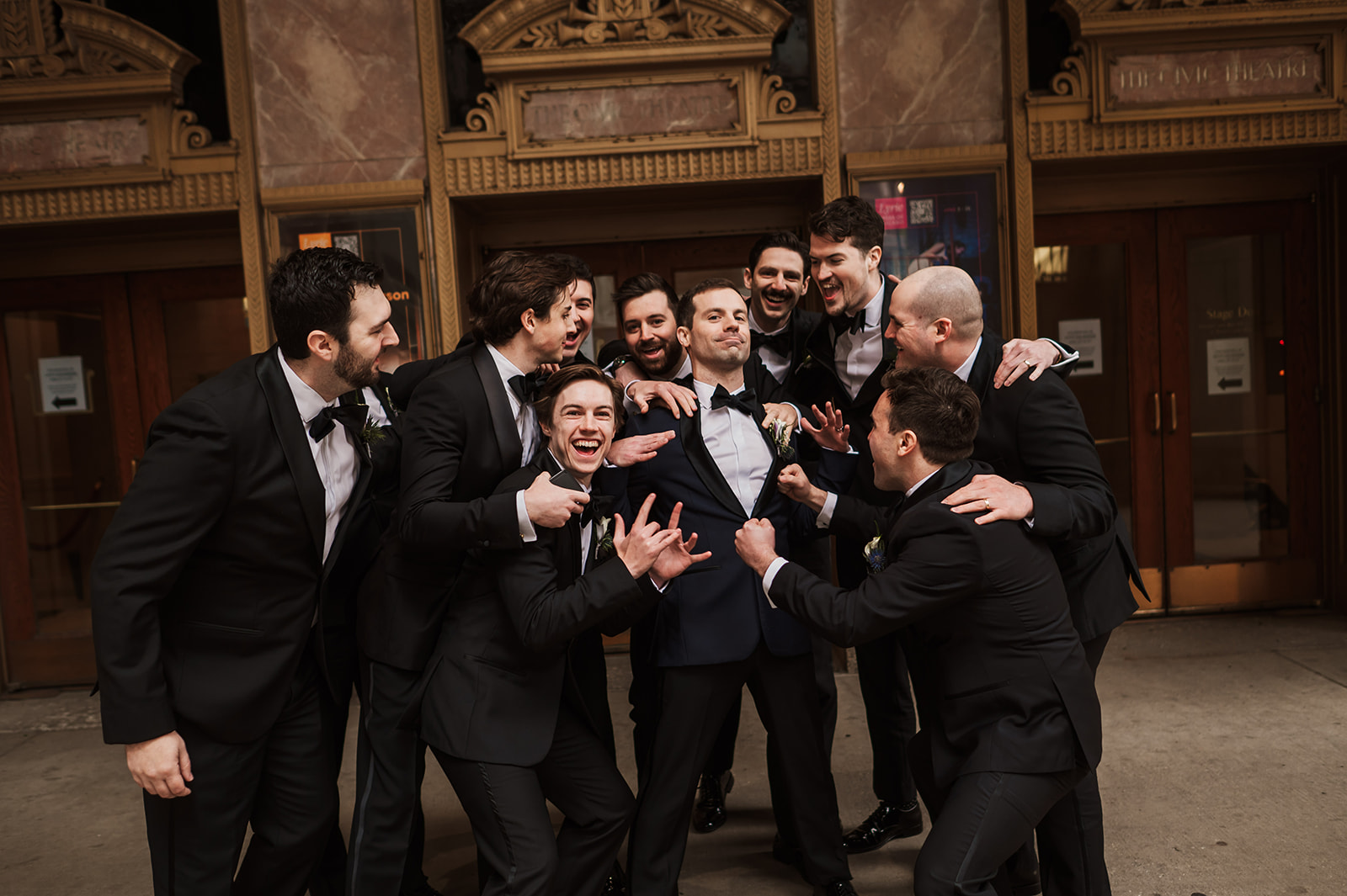 crazy wedding party photos at the Lyric Opera Chicago. black dresses and black suits