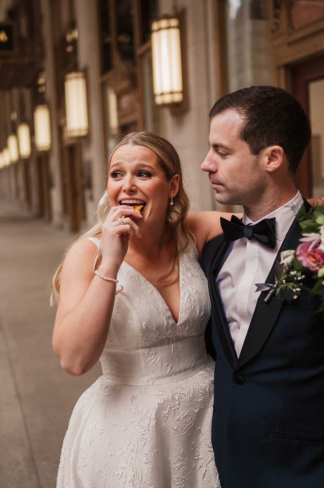 epic bride and groom wedding photos at the Lyric Opera Chicago. documentary photography bride eating pretzels 