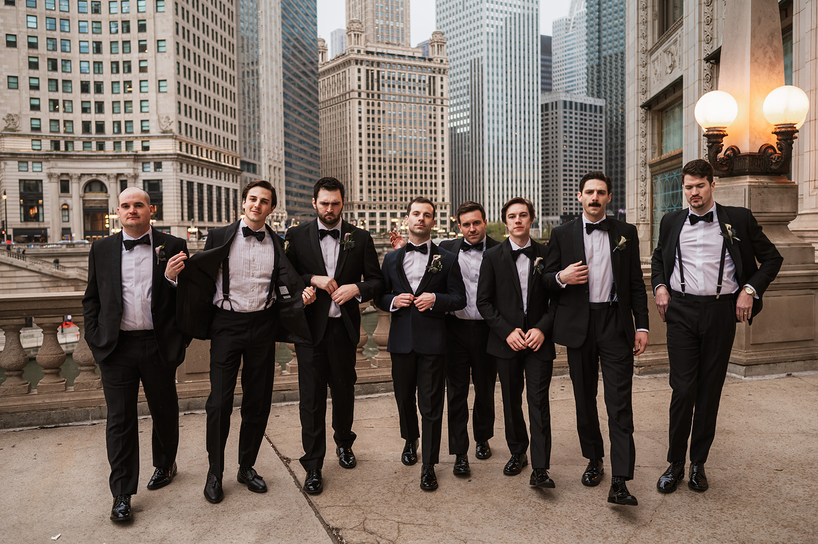 groomsmen at the end of the winter on riverwalk by the Wrigley building chicago