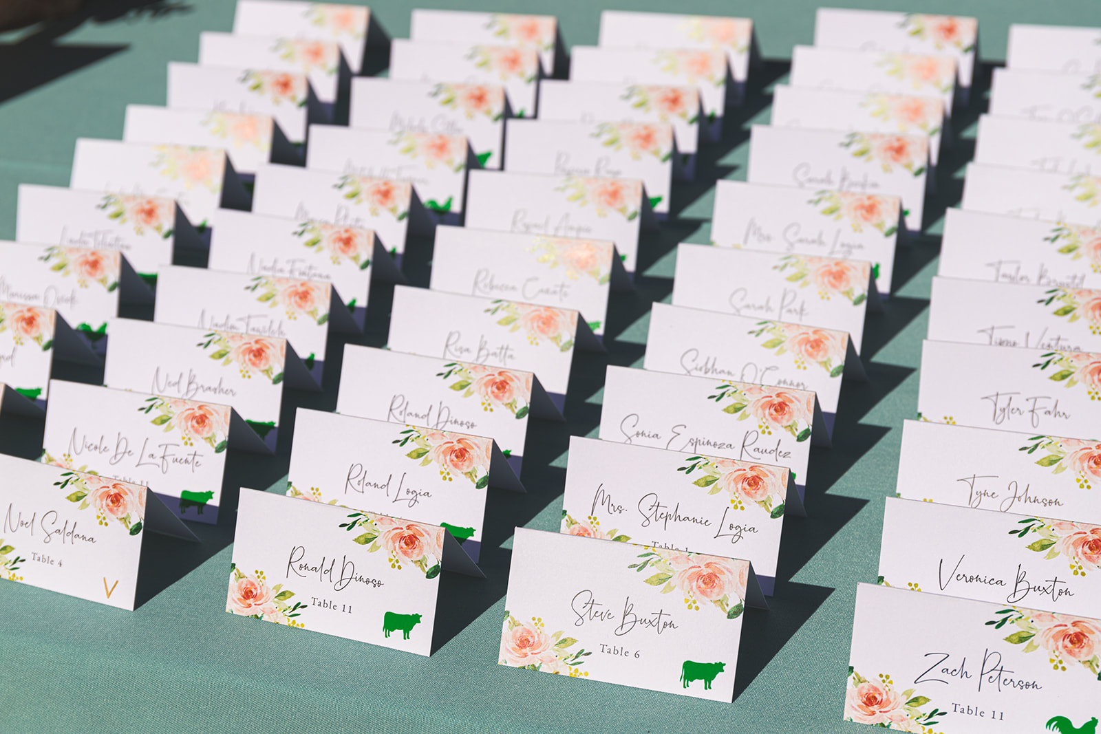 Name cards with pink florals for a wedding