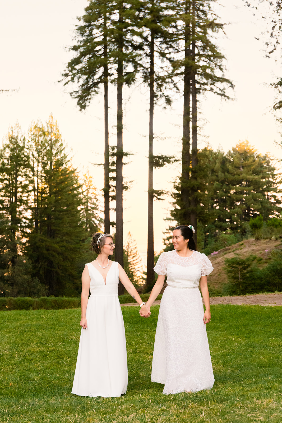 two brides hold hands at their lesbian wedding