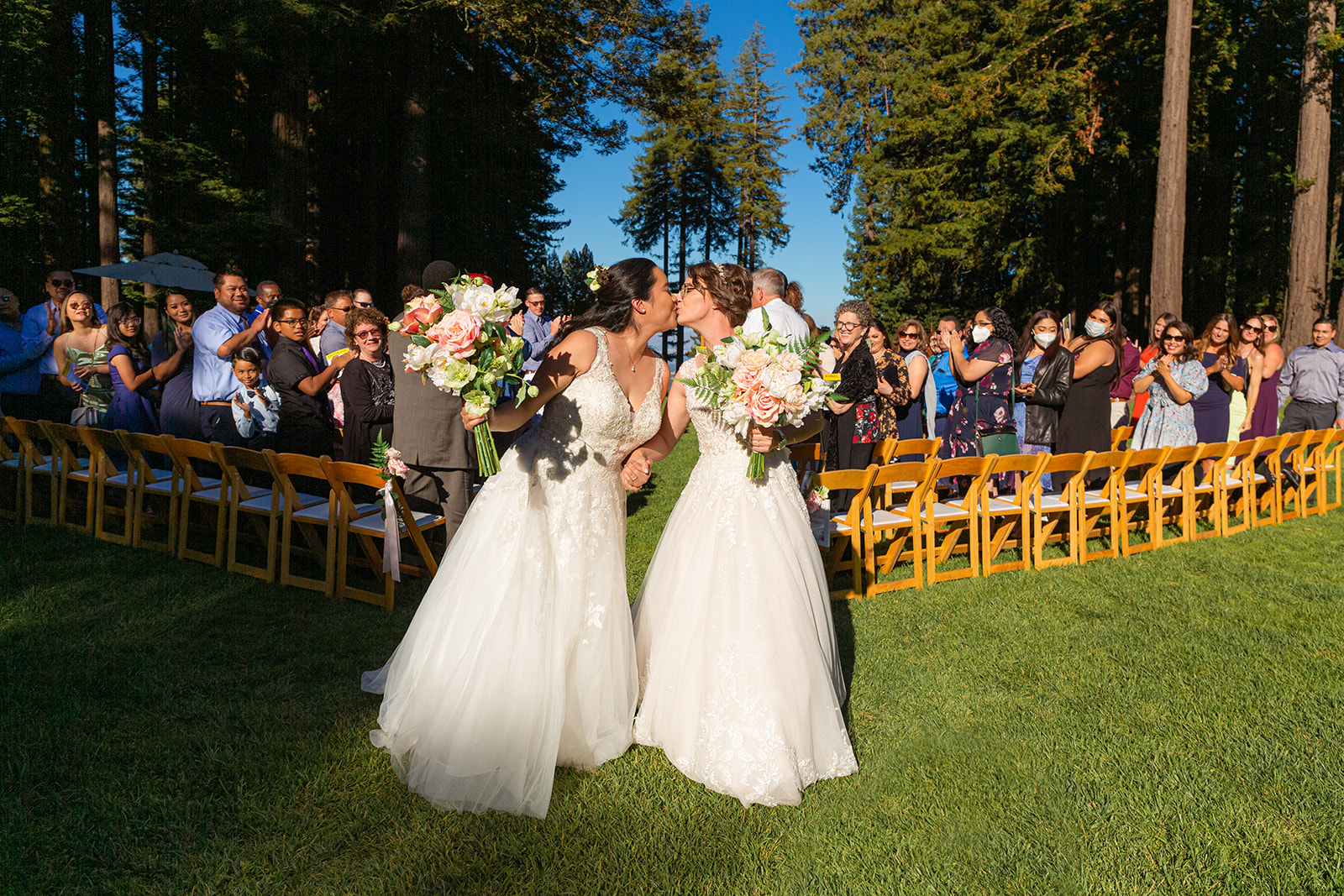 two brides share a kiss at their redwoods wedding in woodside california