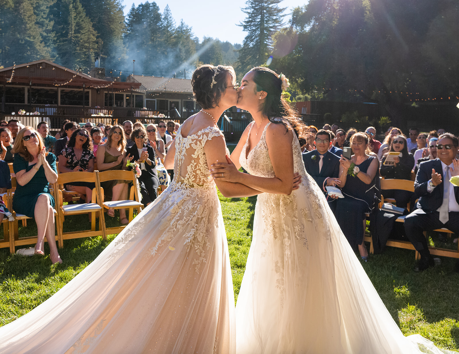 two brides share their first kiss as wives in a reverse first kiss photo