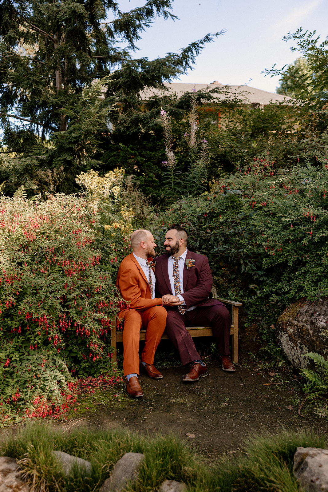 Two grooms posing for portraits at their Oregon Garden wedding. 