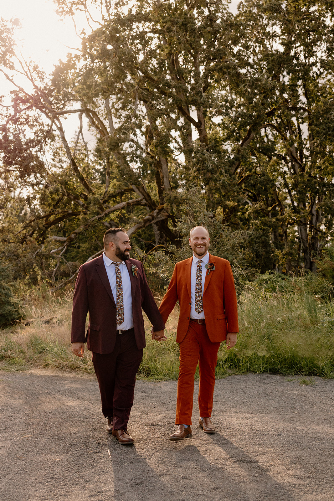 Two grooms posing for photos at sunset at the Oregon Garden.