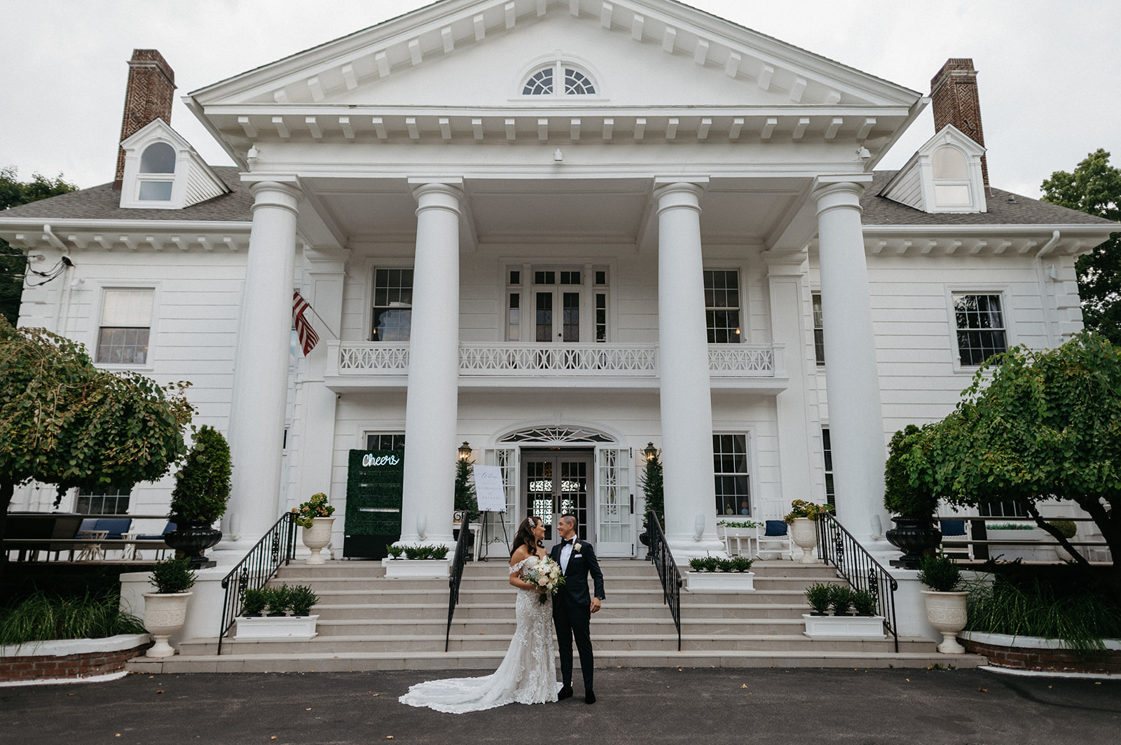 Brides pose together in front of hudson valley wedding venue the briarcliff manor