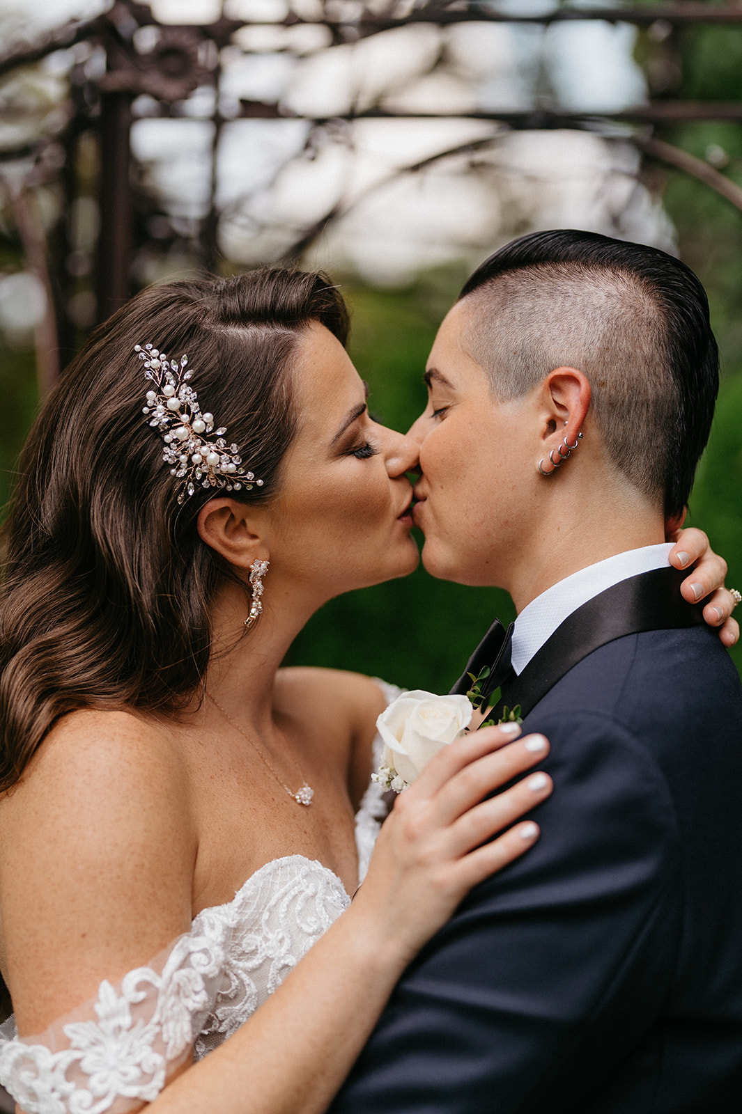 Brides kiss during wedding portraits at hudson valley wedding