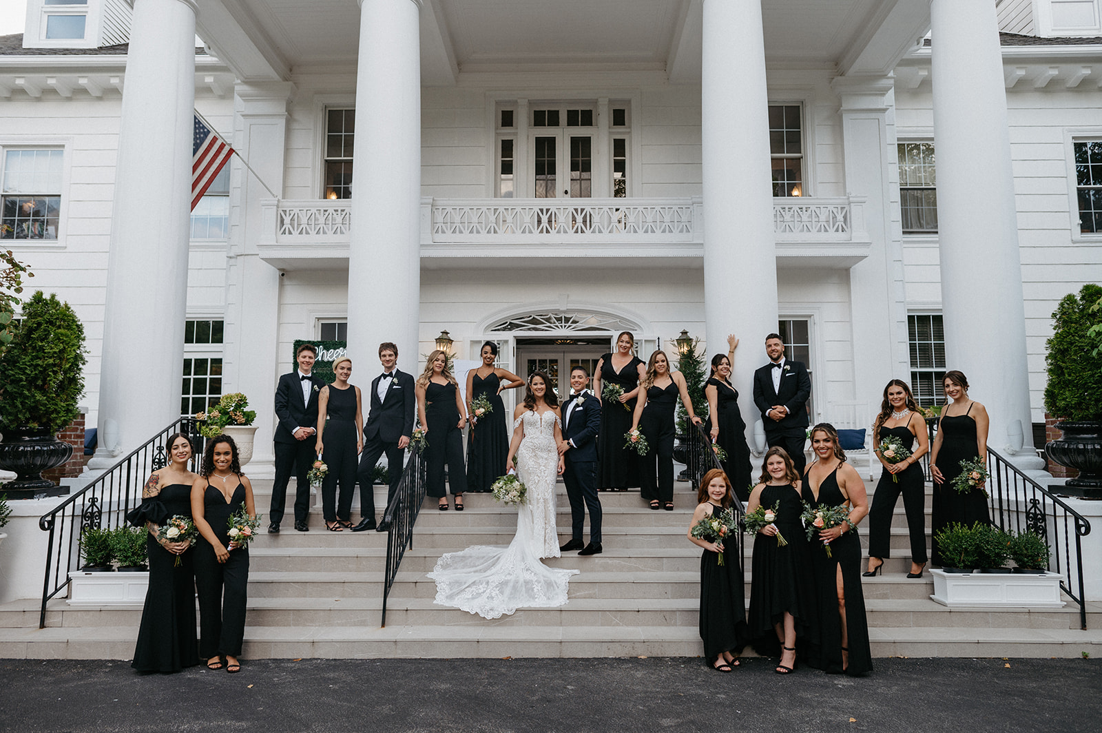 wedding party pose for portrait on the steps of the briarcliff manor wedding venue