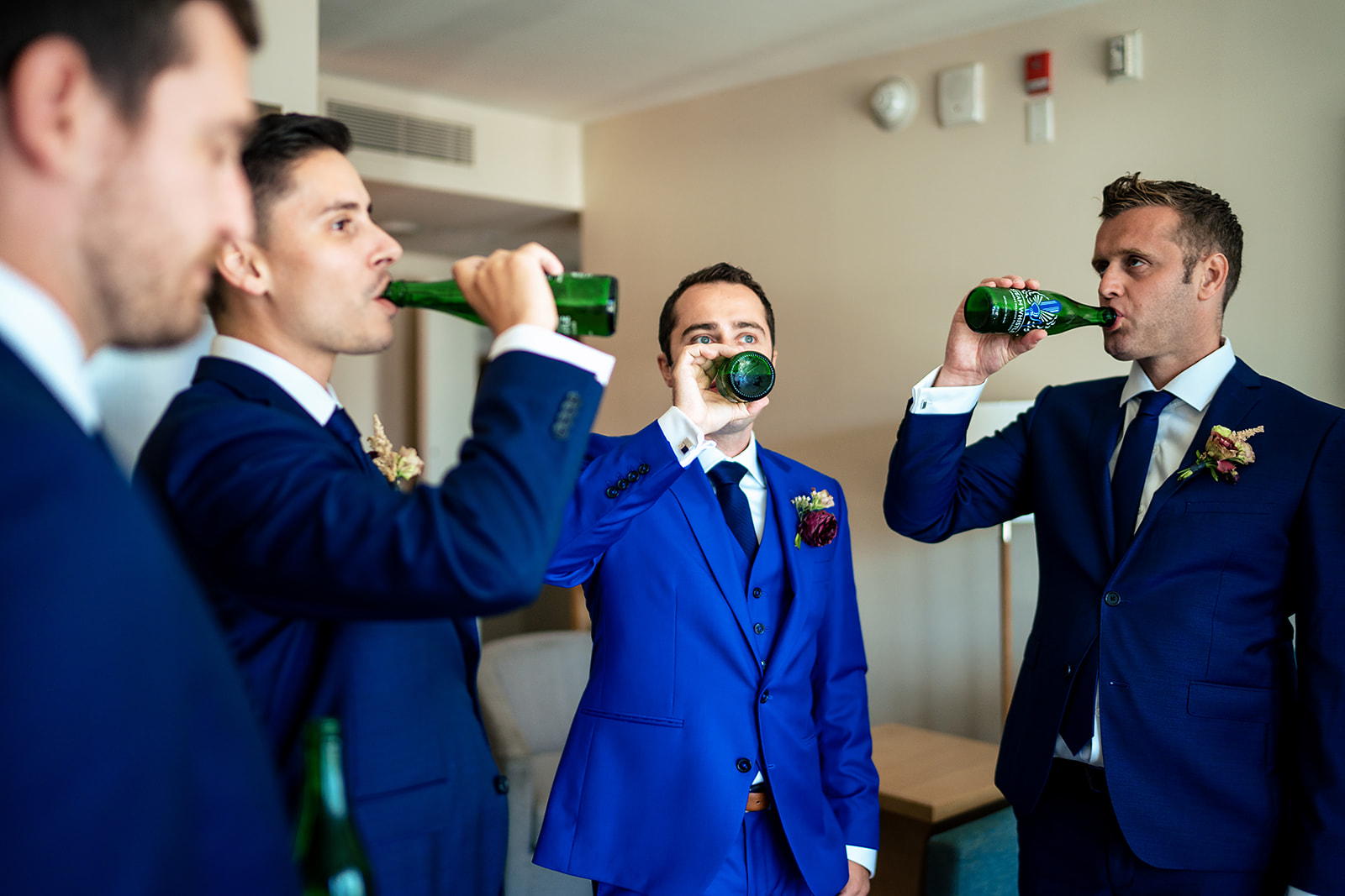 Groom and the groomsmen drinking beer 