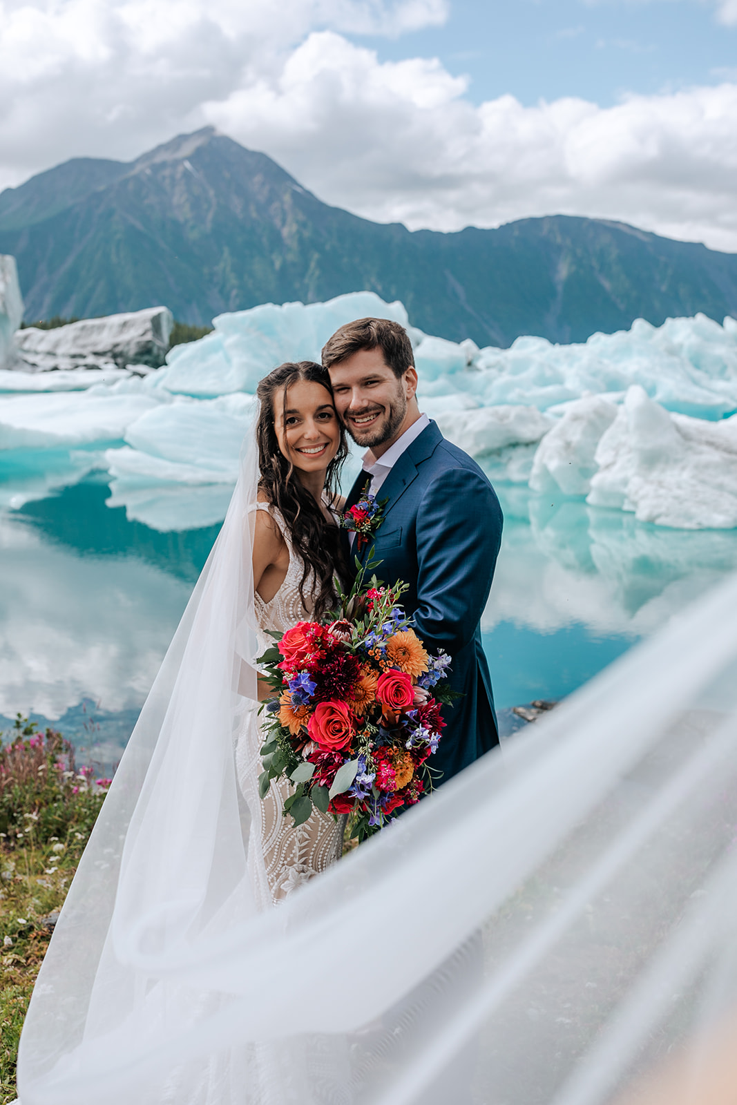 bride and groom with icebergs in alaska