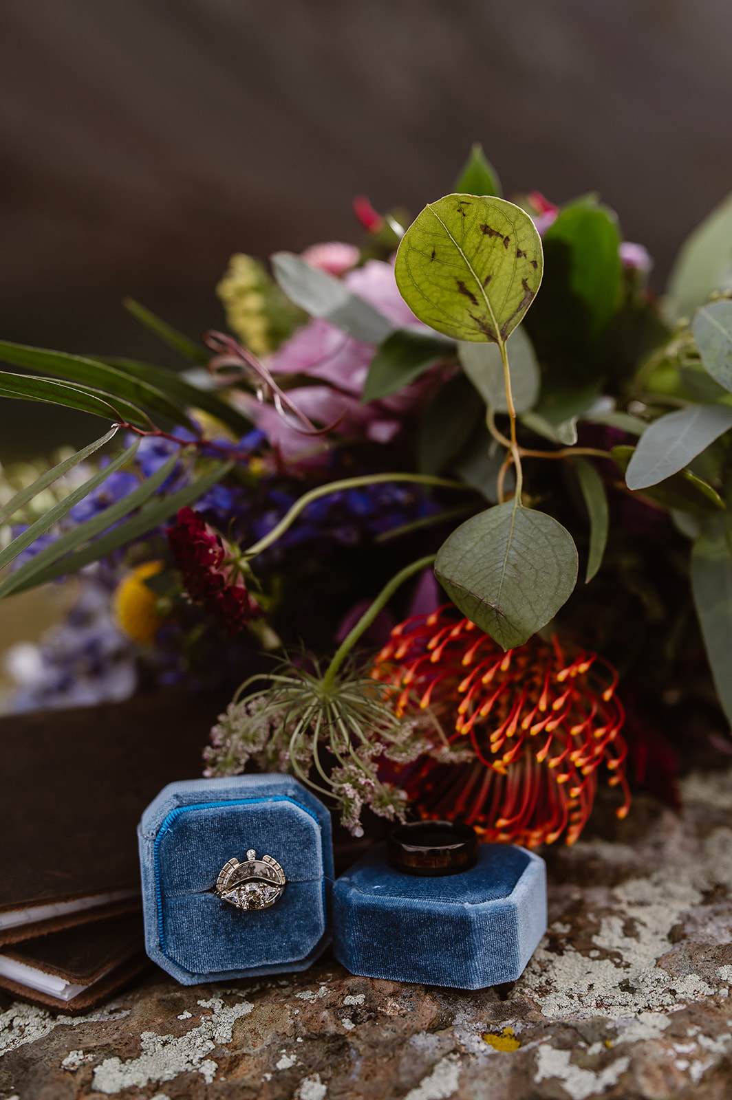 Details for Clear Lake adventure elopement. Bouquet, rings and leather vow books. 