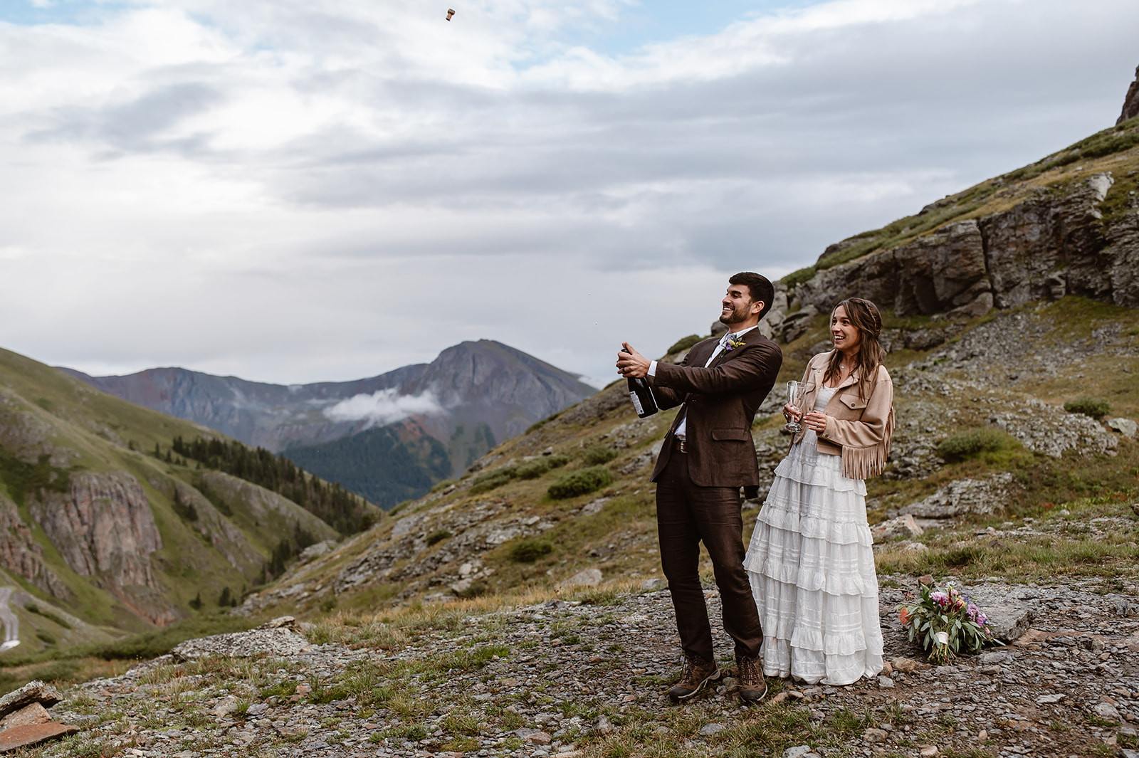 Couple popping champagne during their adventure elopement near Ouray colorado 