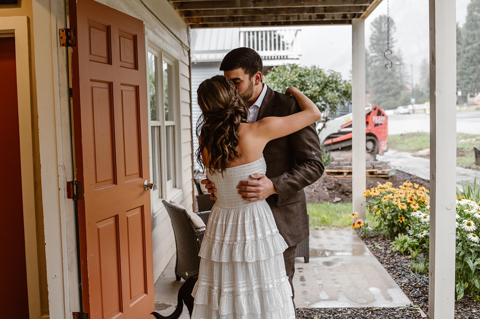Couple embracing after their first look in Ouray Colorado for their elopements while it rains.