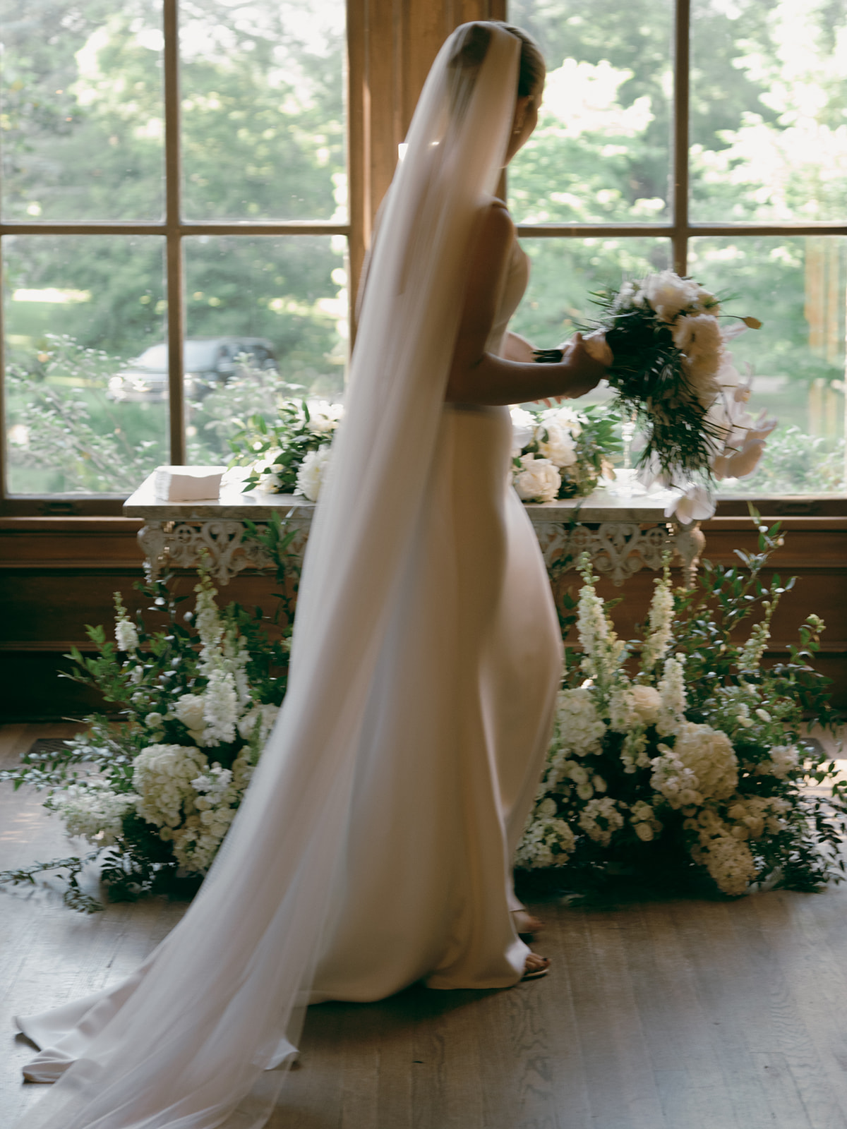 The bride wore a dramatic cathedral veil with a classic and simple wedding gown at this Annesdale Mansion wedding 