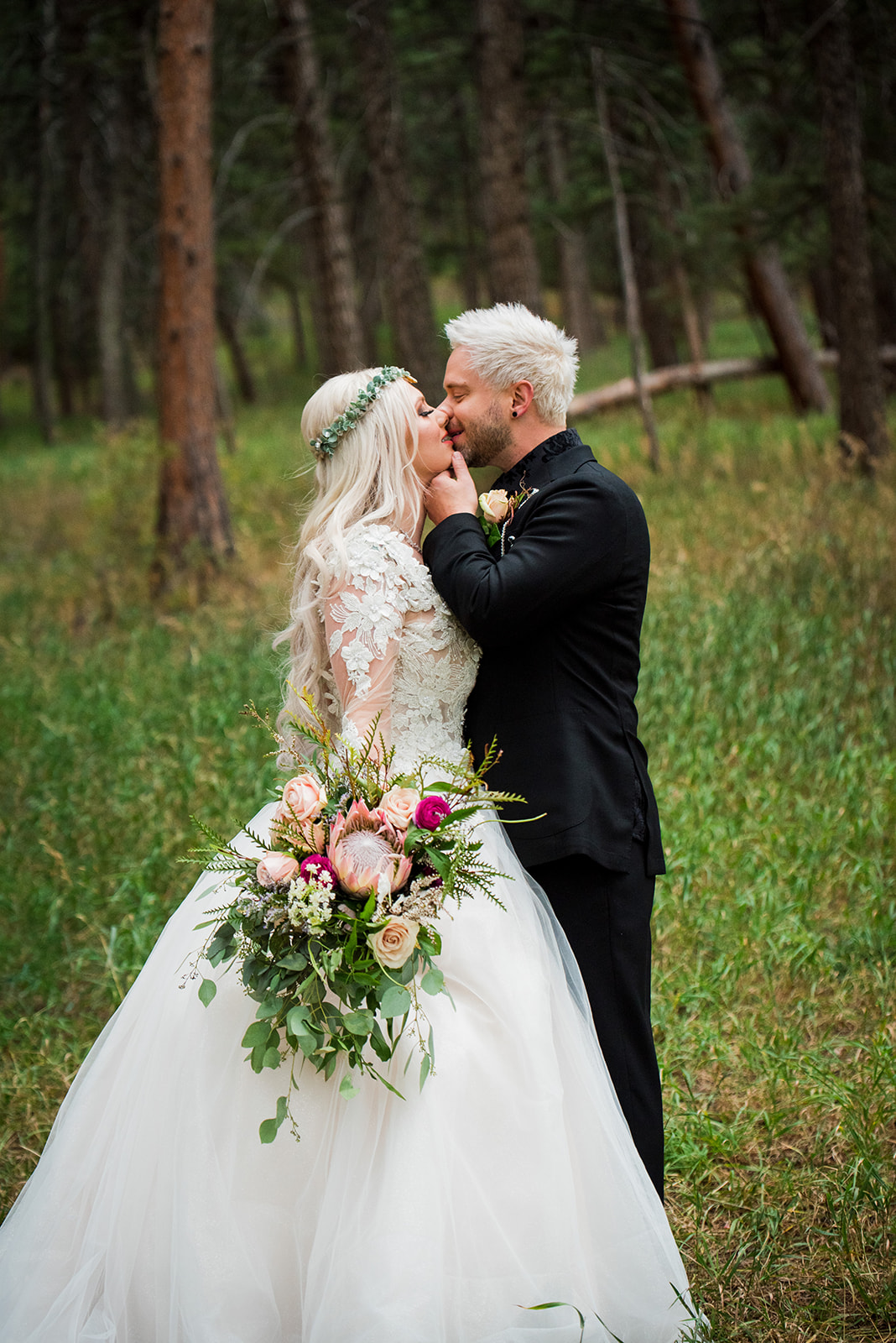 Bride and groom share a kiss in an enchanting forest.