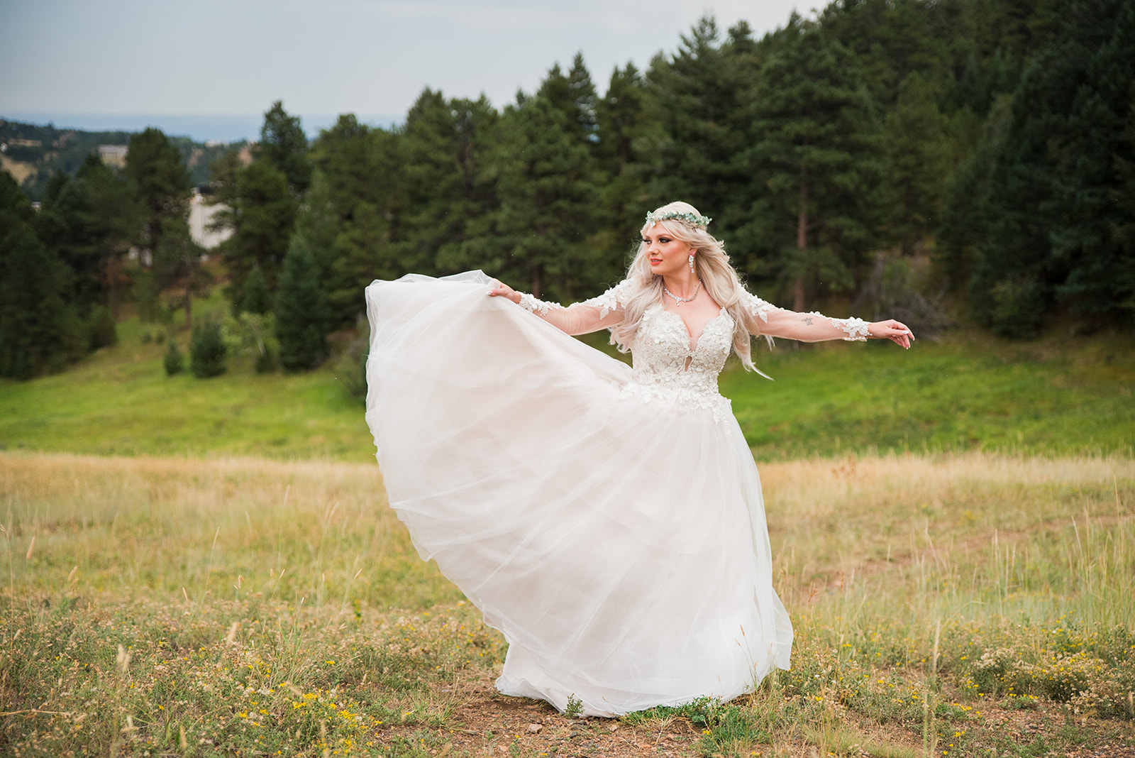 Bride twirls in an open field, showing off her dress.