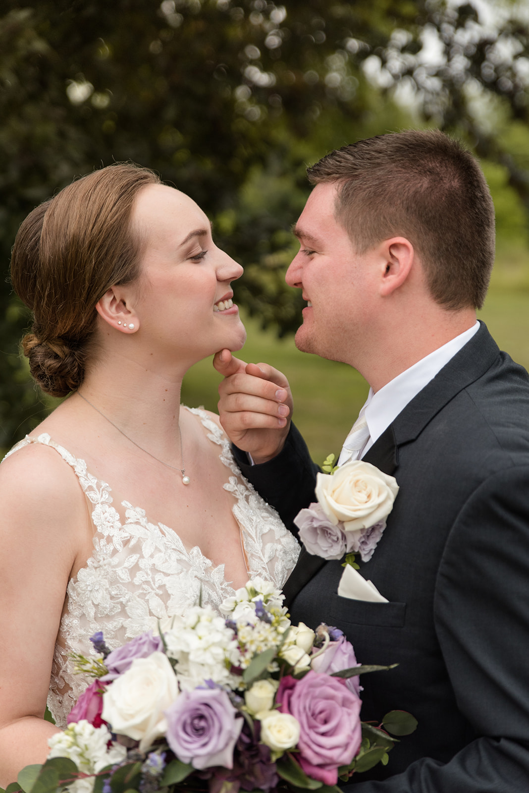Bride and groom share a quiet, unscripted moment together during their wedding portraits in Eau Claire, Wisconsin