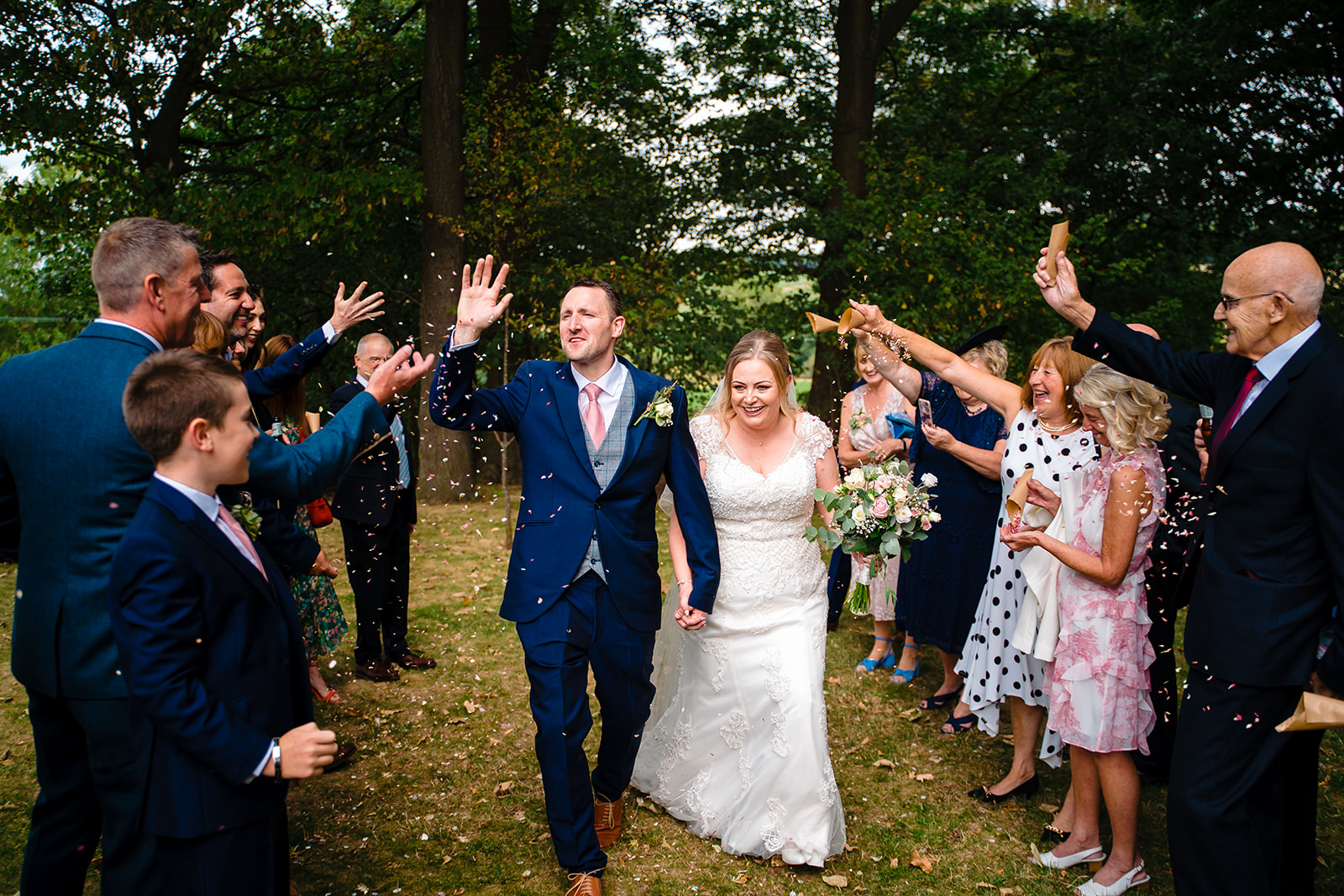 confetti thrown over couple at a 315 Wedding in lepton