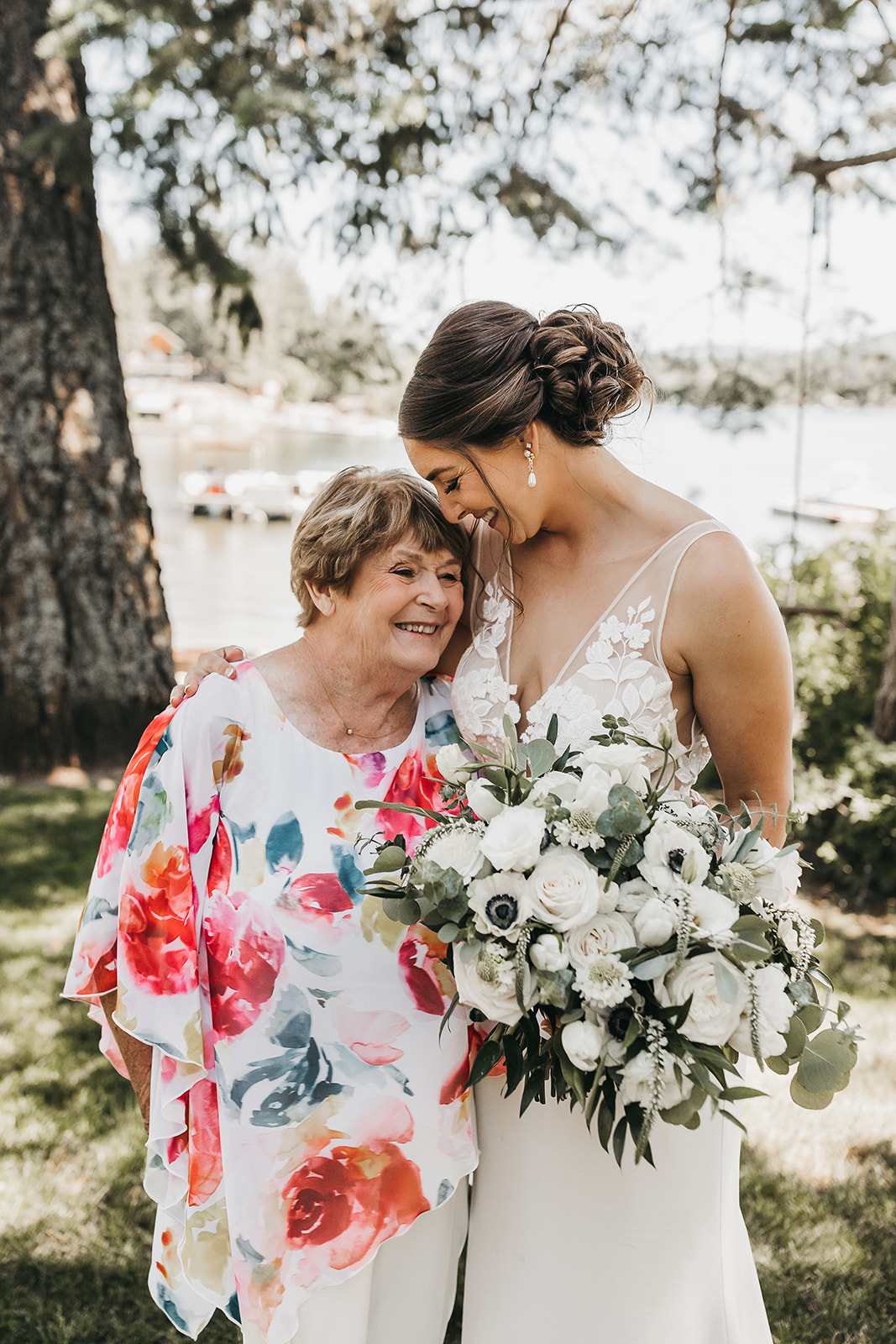 Bride with grandmother at private lake front property wedding.
