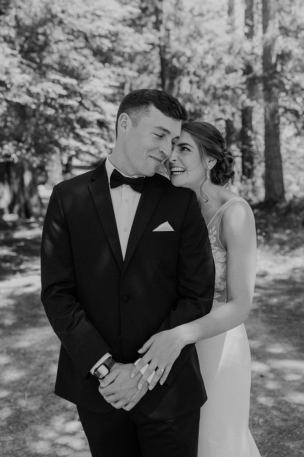Bride and groom special moment black and white photo at private lake front property wedding.