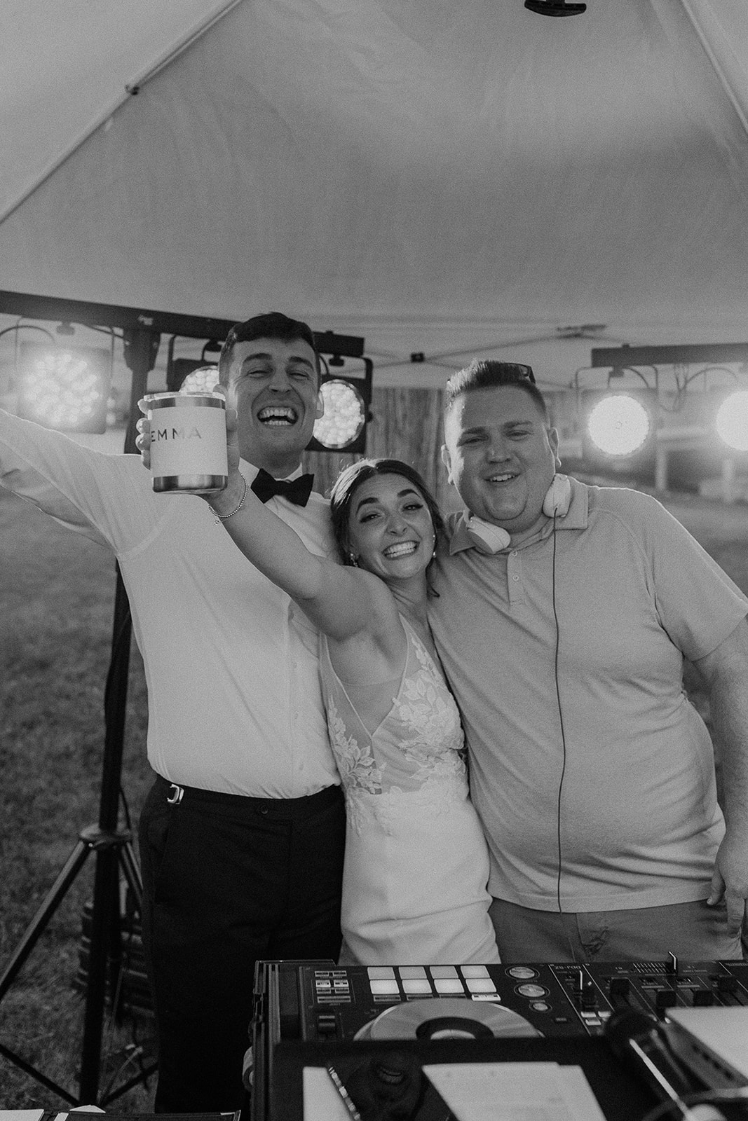 Bride and groom hanging out with their DJ at wedding reception getting the party started.