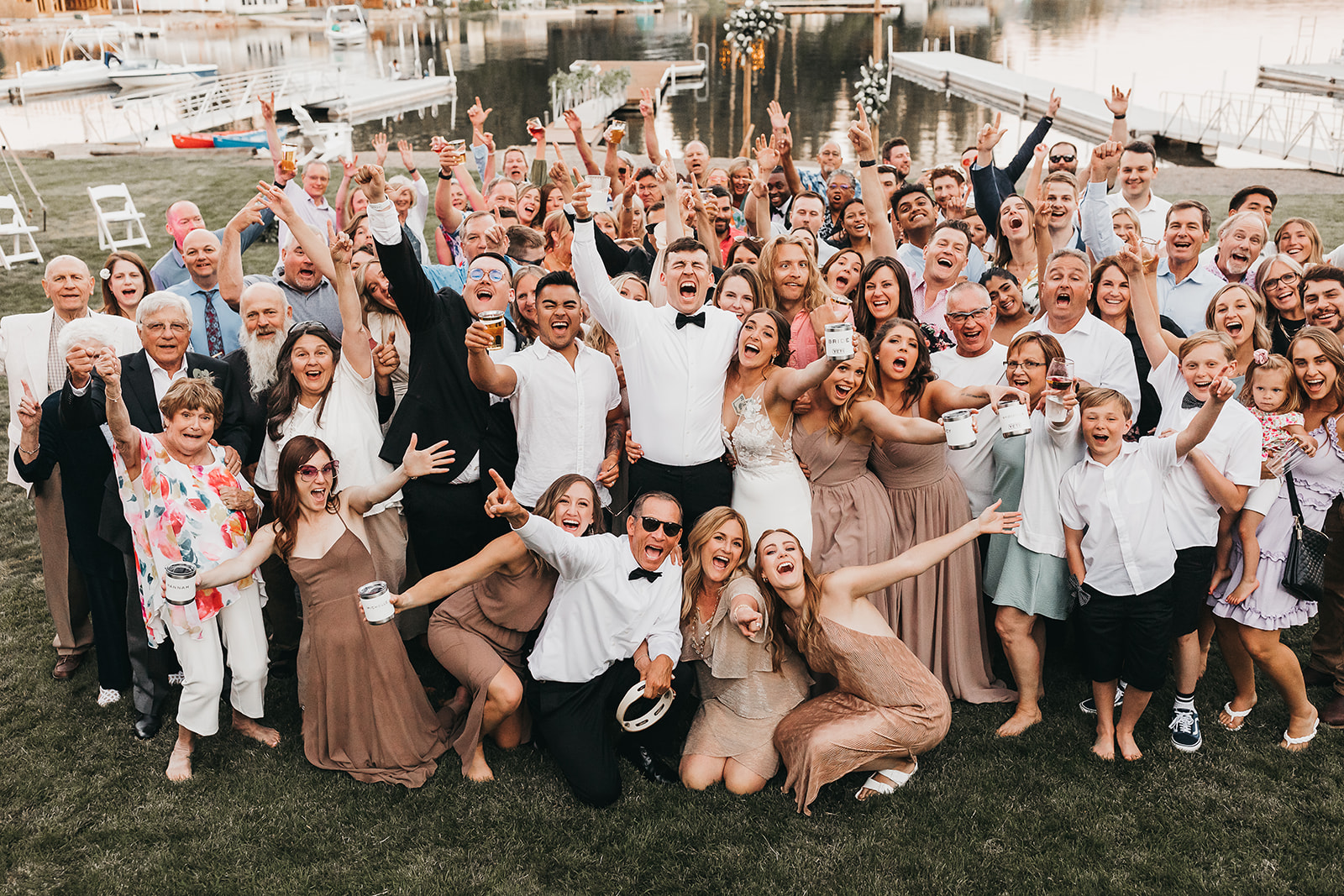 Wedding party and guest get together for a fun picture with private dock at family lake house!