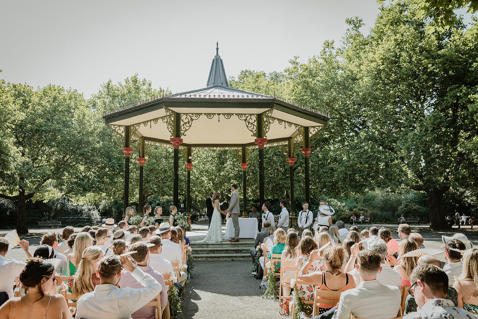 Bride and groom exchange vows in the historical band stand in Battersea Park