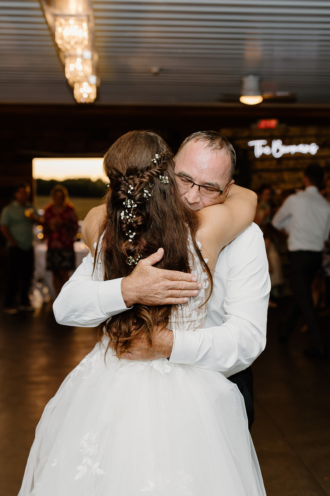Bride and her father share a hug