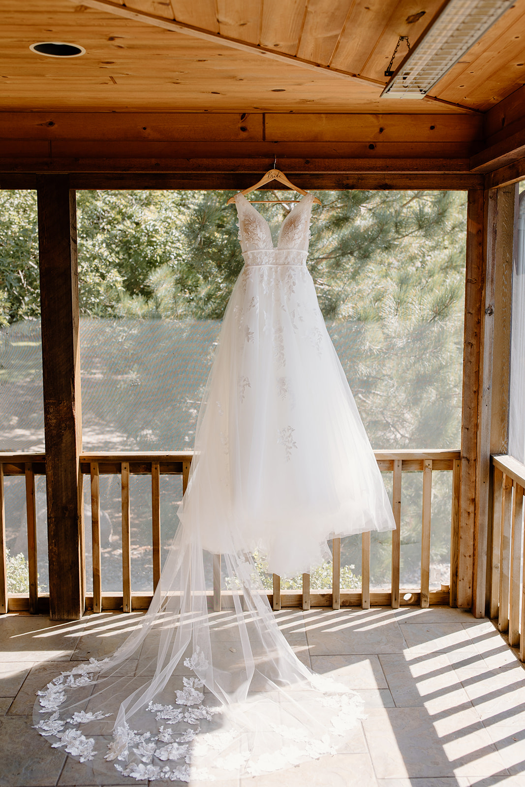 Wedding dress hanging up inside a porch