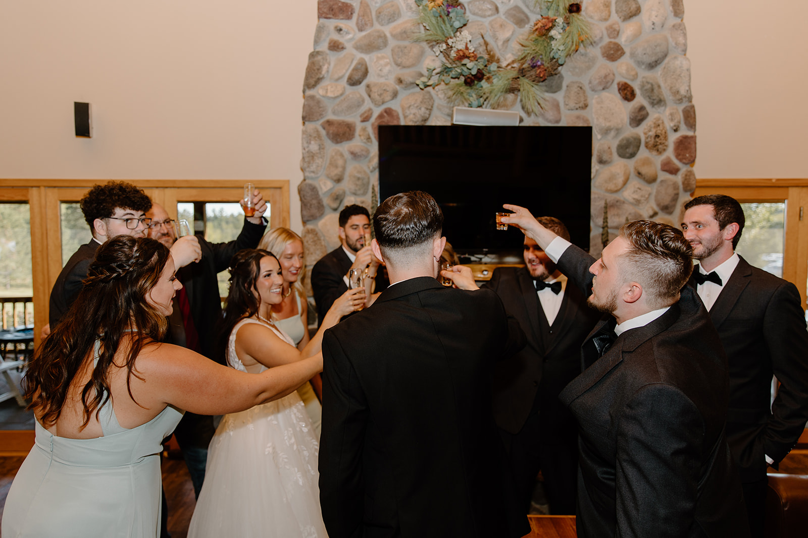 Wedding party cheers with a drink in hand