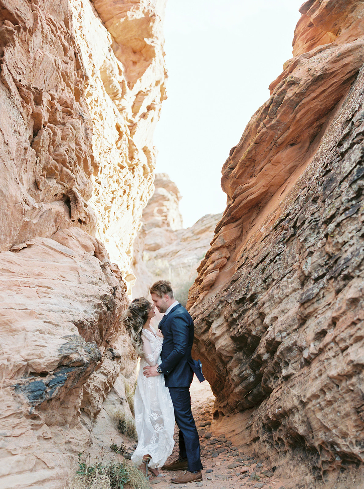 bride and groom kissing in a slot canyon in zion national park
