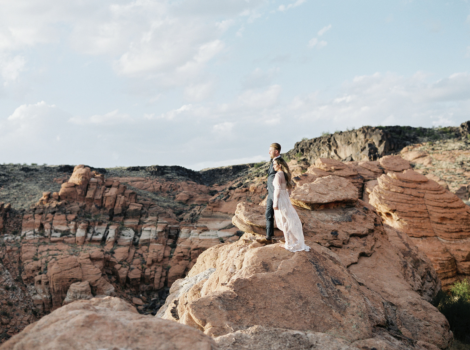 bride and groom standing on cliff edge during their adventure elopement in zion national park 