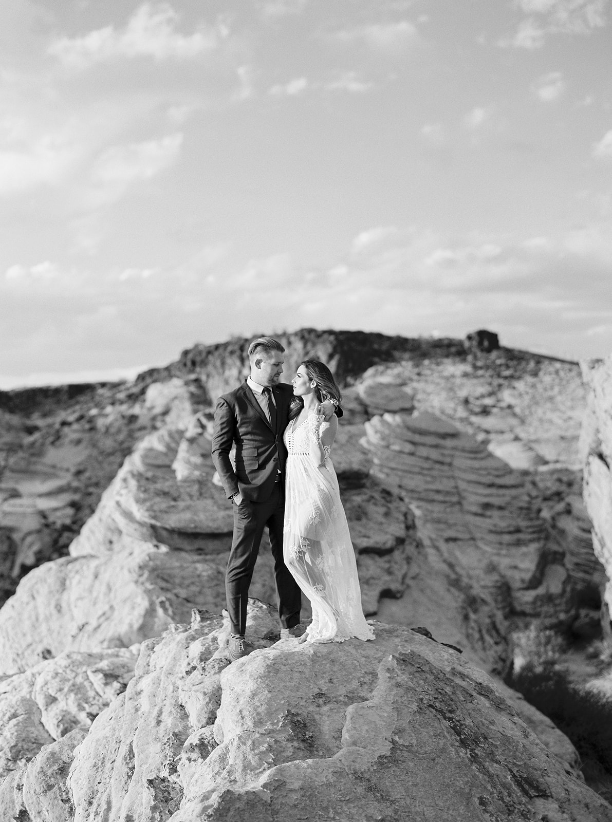 Bride and groom during exploring the red rock formations during their Zion National Park Elopement. 