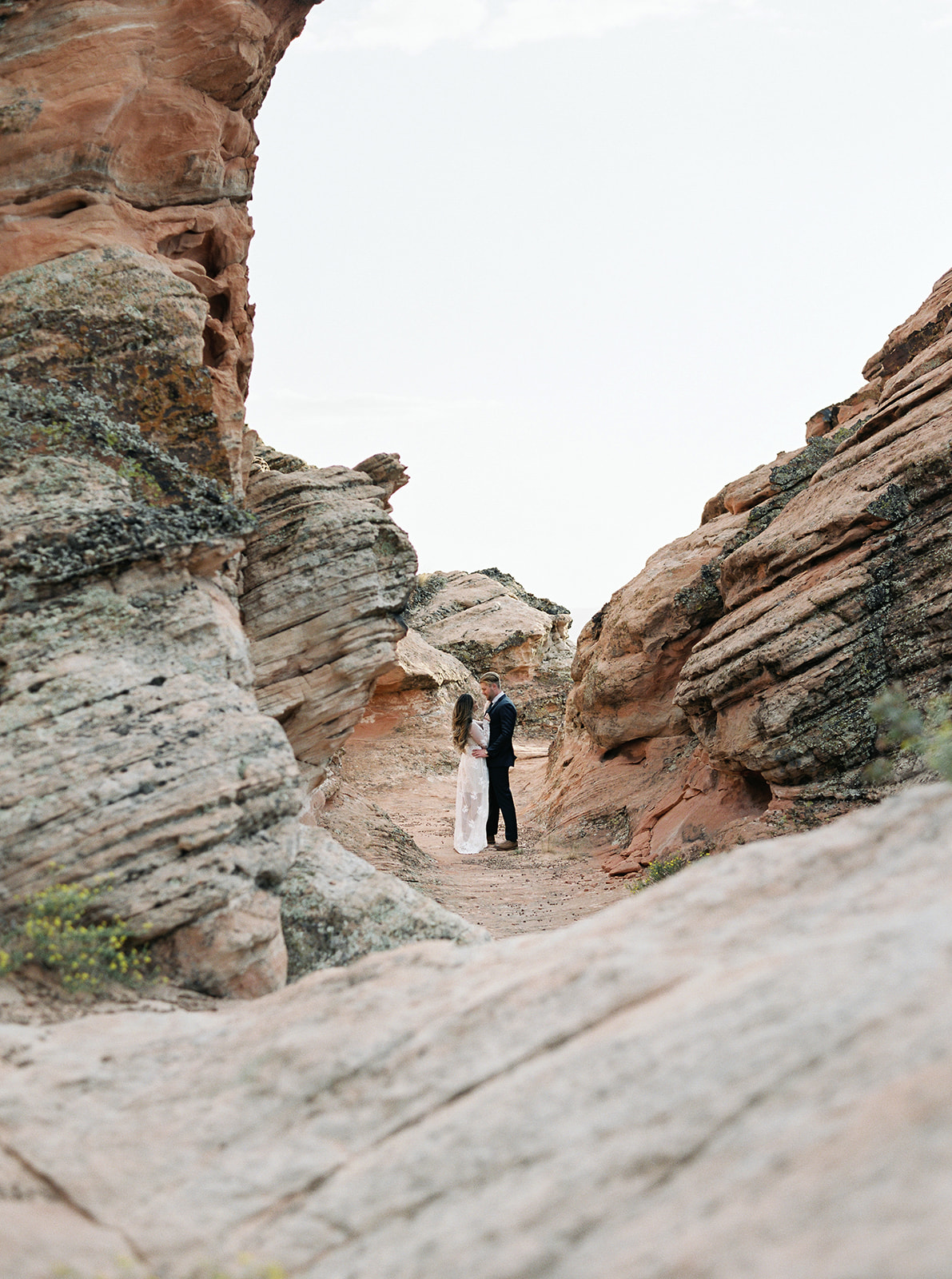 A bride and groom exploring the red rocks in Utah on their Elopement day in Zion National Park!