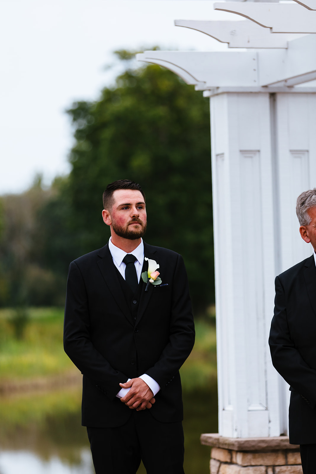 Groom watches his bride walk down the aisle in Syracuse, NY.