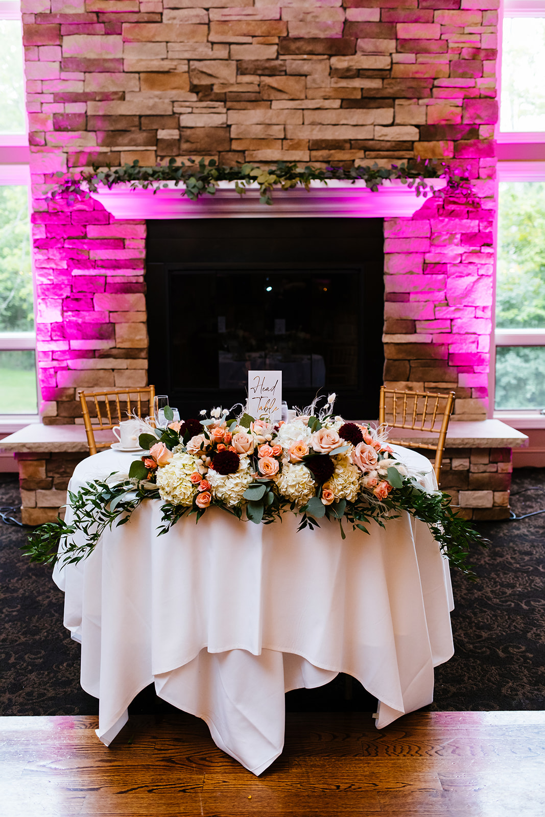 The head table at a wedding at Traditions in Syracuse, NY. Flowers by whistlestop florist.